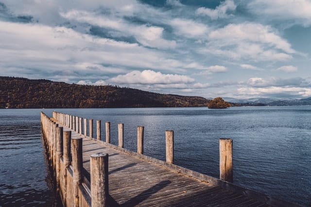 A Lake District lake below rolling green fells